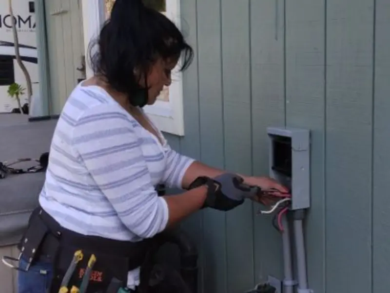 Licensed electrician wiring an exterior subpanel in Wolcott